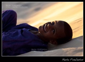 Tuareg boy enjoying late afternoon sun in Sahara desert Tuareg boy enjoying late afternoon sun in Sahara desert